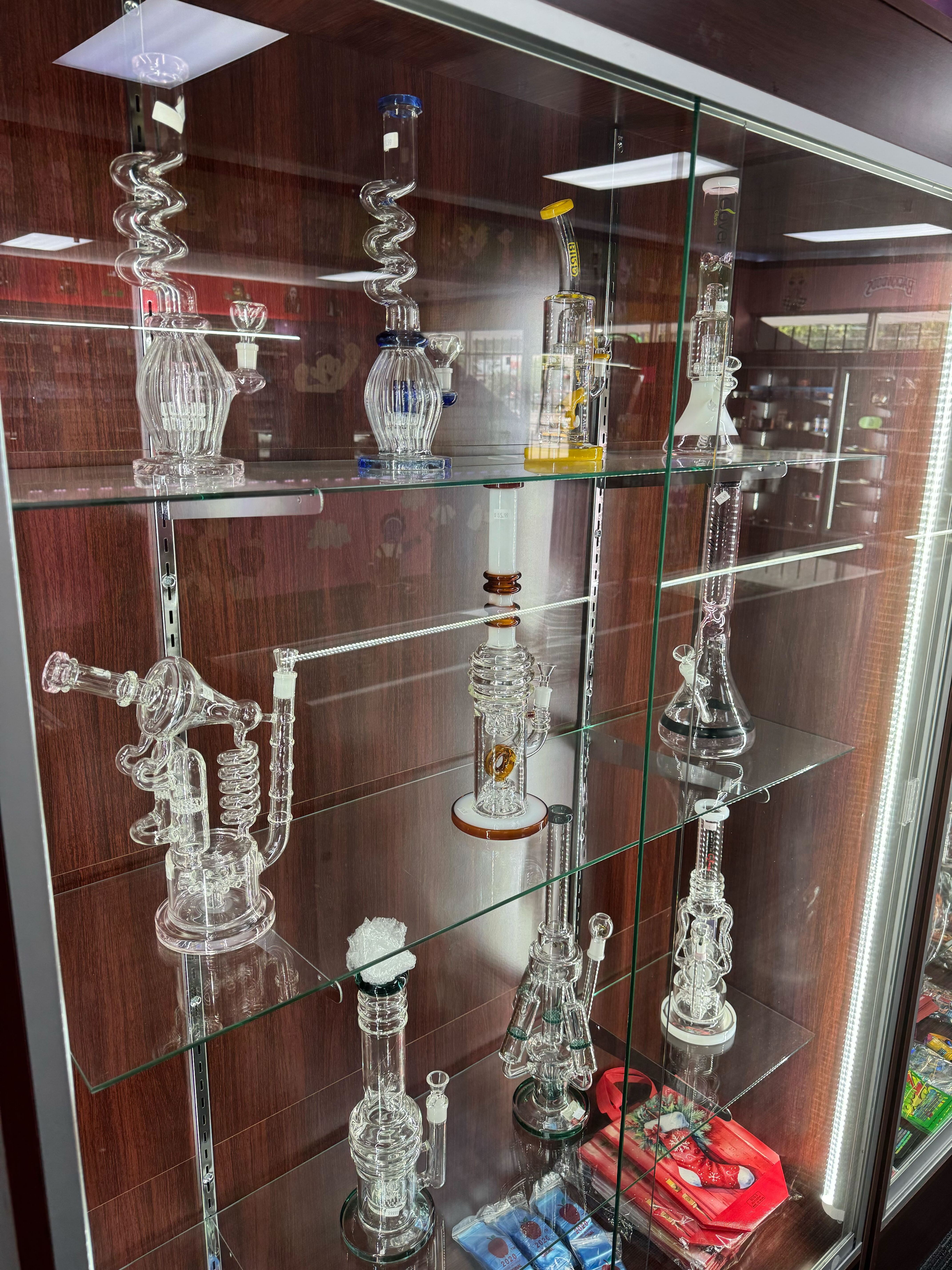 Display case filled with intricate glass smoking devices and accessories